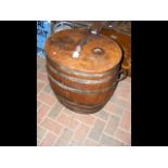 An old two handled metal bound barrel with lid