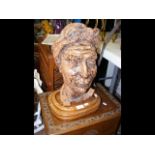 A terracotta bust on wooden plinth - H48cm