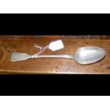 A large silver basting spoon with London hallmark