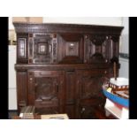 A large antique carved continental oak cupboard wi