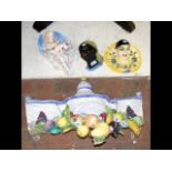 A 63cm ceramic wall ornament depicting fruit, toge