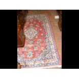 A Middle Eastern style carpet, with red ground and