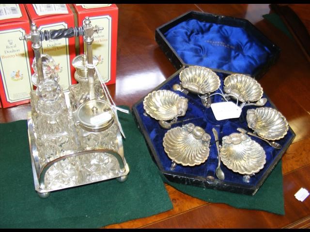 A set of six silver plated shell table salts with