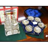 A set of six silver plated shell table salts with