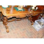 A Victorian rosewood library table, on stretcher b