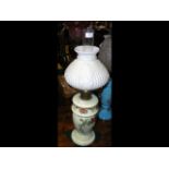 A floral decorated oil lamp with embossed milk gla