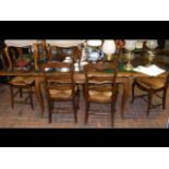 An antique French extending dining table on cabrio