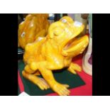 An antique orange glazed frog figure with impresse