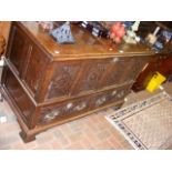 An antique oak mule chest with two drawers to the