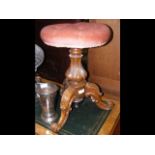 A Victorian carved walnut revolving piano stool