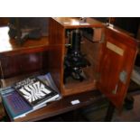 A Watson microscope with fitted case and book