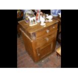 A pine cupboard with drawer to the top