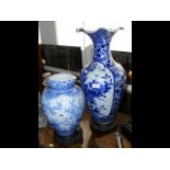 A blue and white oriental vase with flared rim on