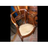 An antique carver chair with curved backrest