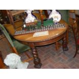 An oak extending dining table on barley twist supp