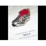 A silver 'boot' pin cushion