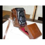 A Rolleiflex Camera in leather case
