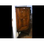 A 19th century oak corner cupboard on stand