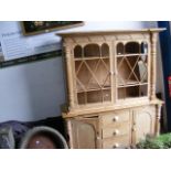 A Victorian pine bookcase with glazed upper sectio