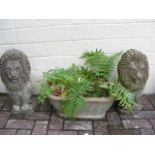 A pair of decorative garden lion ornaments, togeth