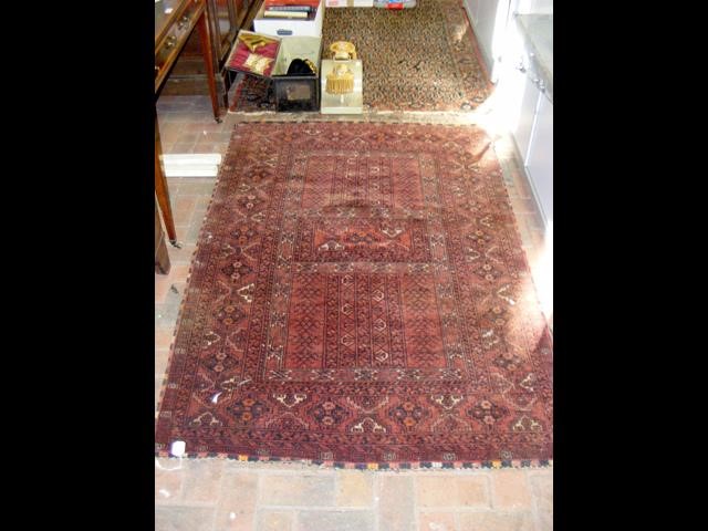 A Middle Eastern rug with red ground - 180cm x 120