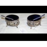 A pair of oval silver salts, with blue glass liner