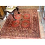 An antique Middle Eastern rug with geometric borde