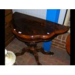 A 19th century rosewood fold-over games table with