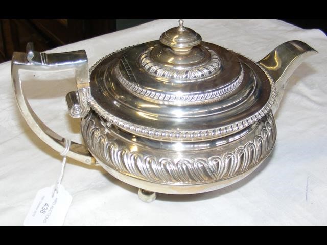 A decorative silver Georgian teapot with gadroon e