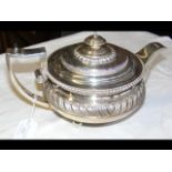 A decorative silver Georgian teapot with gadroon e