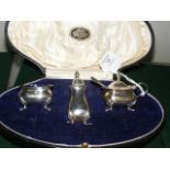 A three piece silver condiment set by James Walker