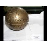 An antique pierced brass hand warmer with gimballed