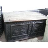 A small carved oak blanket chest