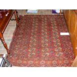 An antique Middle Eastern rug with geometric borde