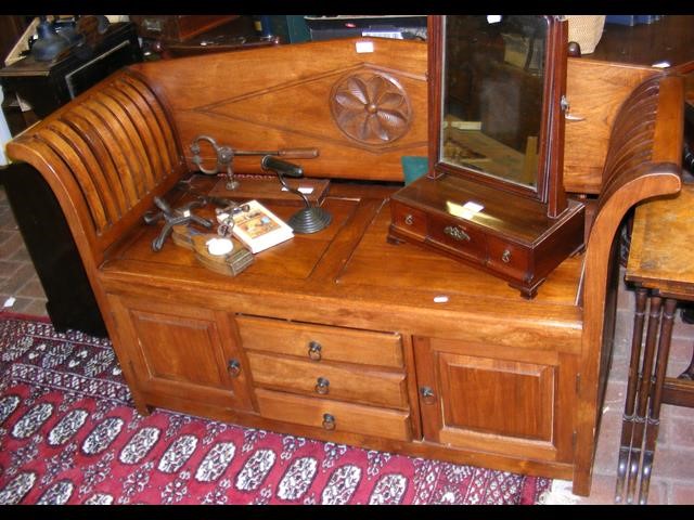 A hardwood hall seat with drawers and cupboards be