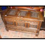 A carved oak coffer with drawer to base - 110cm