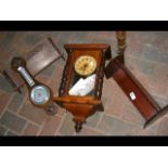 A Victorian wall clock with visible pendulum, toge
