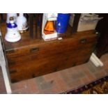 An antique camphorwood chest with sunken handles