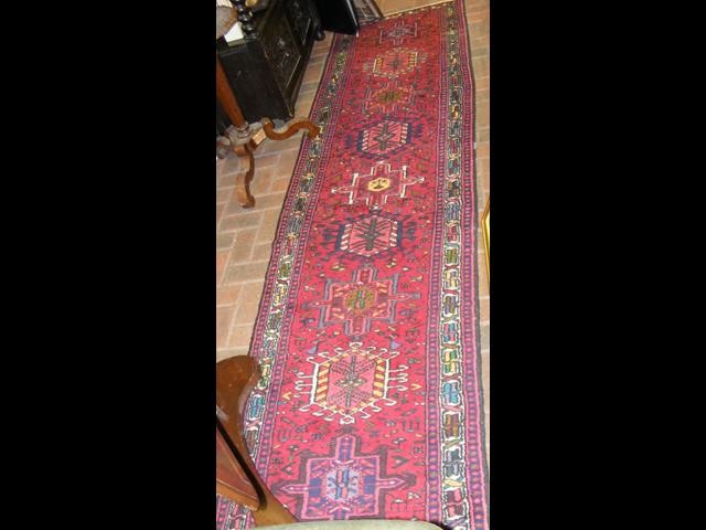 A Middle Eastern red ground runner with geometric