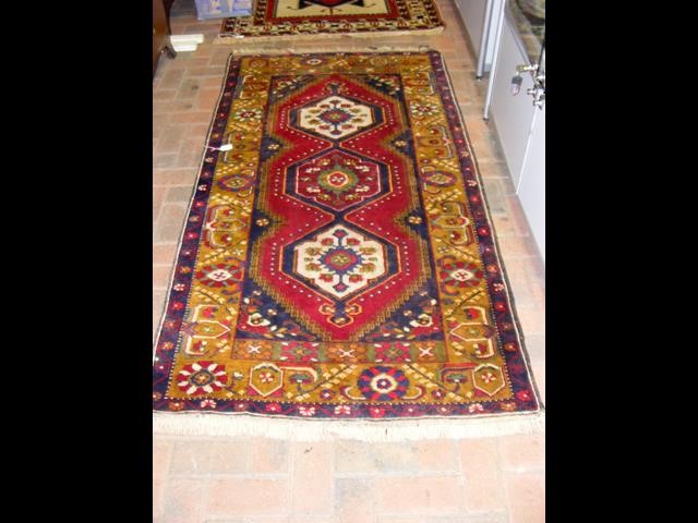 A Middle Eastern rug with triple diamond design to