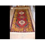 A Middle Eastern rug with triple diamond design to