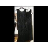 Two black vintage dresses decorated with black bea