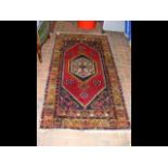 A Middle Eastern red ground rug with triple border