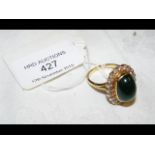 An emerald and diamond ring in 18ct gold setting