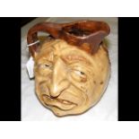 A Martin Brothers style grotesque pottery jug - 15cm hig