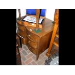 A mahogany chest of drawers with shaped front - wi