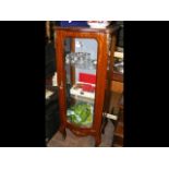 A French style serpentine fronted display cabinet