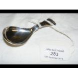 A silver caddy spoon