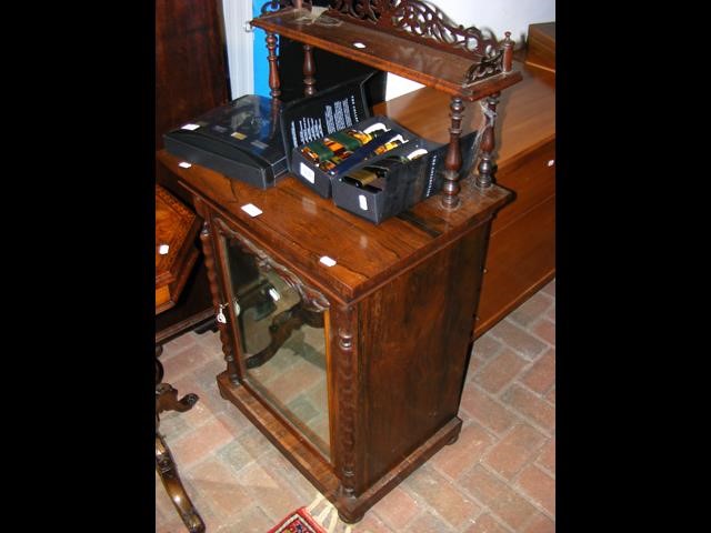 A mid Victorian rosewood chiffonier with shelf to