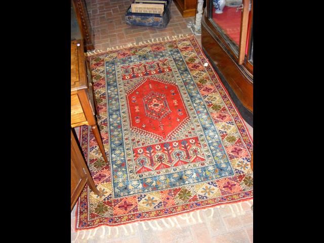 A Middle Eastern rug with geometric and floral pat